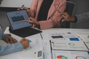 Close up of Business team analyzing income charts and graphs with modern laptop computer. Business analysis and strategy concept. photo