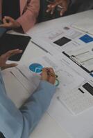 Close up of Business team analyzing income charts and graphs with modern laptop computer. Business analysis and strategy concept. photo