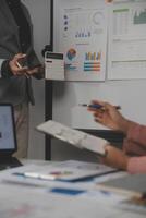 Close up of Business team analyzing income charts and graphs with modern laptop computer. Business analysis and strategy concept. photo