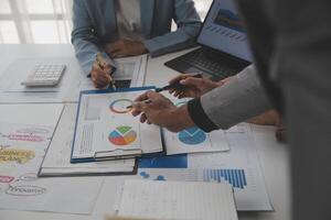 Close up of Business team analyzing income charts and graphs with modern laptop computer. Business analysis and strategy concept. photo