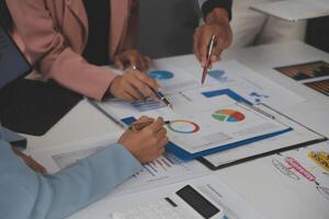 Close up of Business team analyzing income charts and graphs with modern laptop computer. Business analysis and strategy concept. photo