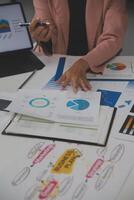Close up of Business team analyzing income charts and graphs with modern laptop computer. Business analysis and strategy concept. photo
