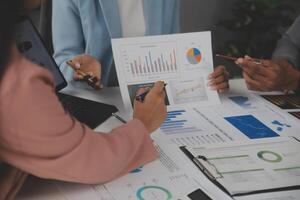 Close up of Business team analyzing income charts and graphs with modern laptop computer. Business analysis and strategy concept. photo