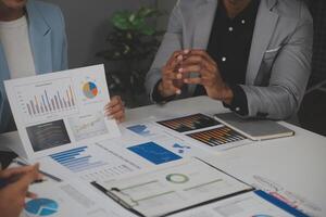 Close up of Business team analyzing income charts and graphs with modern laptop computer. Business analysis and strategy concept. photo