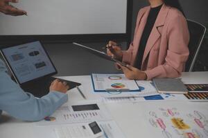 Close up of Business team analyzing income charts and graphs with modern laptop computer. Business analysis and strategy concept. photo