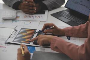 Close up of Business team analyzing income charts and graphs with modern laptop computer. Business analysis and strategy concept. photo
