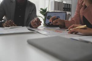 Close up of Business team analyzing income charts and graphs with modern laptop computer. Business analysis and strategy concept. photo