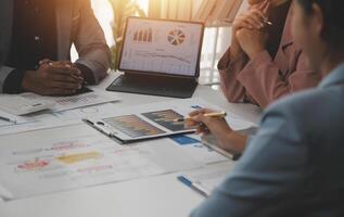 Close up of Business team analyzing income charts and graphs with modern laptop computer. Business analysis and strategy concept. photo
