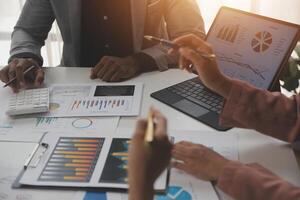 Close up of Business team analyzing income charts and graphs with modern laptop computer. Business analysis and strategy concept. photo
