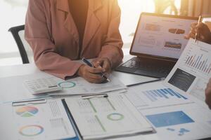 Close up of Business team analyzing income charts and graphs with modern laptop computer. Business analysis and strategy concept. photo