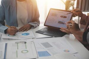 Close up of Business team analyzing income charts and graphs with modern laptop computer. Business analysis and strategy concept. photo