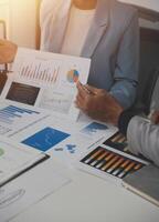 Close up of Business team analyzing income charts and graphs with modern laptop computer. Business analysis and strategy concept. photo