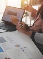 Close up of Business team analyzing income charts and graphs with modern laptop computer. Business analysis and strategy concept. photo