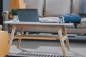Asian SME business women use laptop computer checking customer order online shipping boxes at home. Starting Small business entrepreneur SME freelance. Online business, Work at home concept. photo