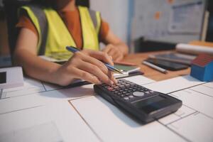 Female architect working at home She looked at the blueprint. photo