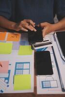 The designer team is designing the uxui system to make the uxui system work well on new phones and support system updates. Website development concept UI UX front end designer photo