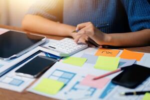 The designer team is designing the uxui system to make the uxui system work well on new phones and support system updates. Website development concept UI UX front end designer photo