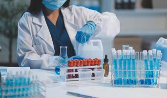 Group of dedicated scientist conduct chemical experiment in medical laboratory, carefully drop precise amount of liquid from pipette into test tube for vaccine drug or antibiotic development. Neoteric photo