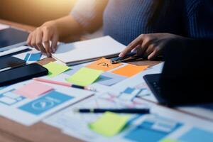 The designer team is designing the uxui system to make the uxui system work well on new phones and support system updates. Website development concept UI UX front end designer photo