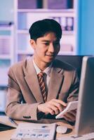 Business accounting concept Businessman uses calculator with laptop computer Budget and borrowed paper Calculate expenses, expenses, taxes online, manage company budgets, close-up images photo