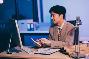 Business accounting concept Businessman uses calculator with laptop computer Budget and borrowed paper Calculate expenses, expenses, taxes online, manage company budgets, close-up images photo