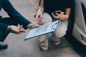 A young businesswoman is navigating car insurance options at her desk, considering premiums, deductibles, and coverage while understanding policies and managing claims efficiently. photo
