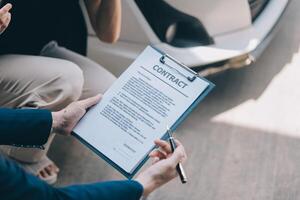 A young businesswoman is navigating car insurance options at her desk, considering premiums, deductibles, and coverage while understanding policies and managing claims efficiently. photo