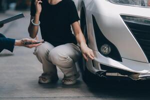 A young businesswoman is navigating car insurance options at her desk, considering premiums, deductibles, and coverage while understanding policies and managing claims efficiently. photo