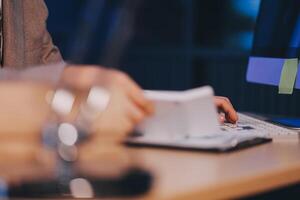 Business accounting concept Businessman uses calculator with laptop computer Budget and borrowed paper Calculate expenses, expenses, taxes online, manage company budgets, close-up images photo