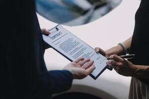 A young businesswoman is navigating car insurance options at her desk, considering premiums, deductibles, and coverage while understanding policies and managing claims efficiently. photo