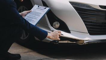A young businesswoman is navigating car insurance options at her desk, considering premiums, deductibles, and coverage while understanding policies and managing claims efficiently. photo