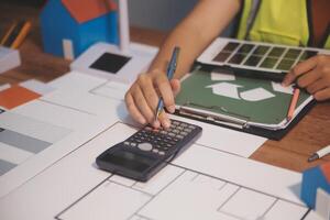 Female architect working at home She looked at the blueprint. photo