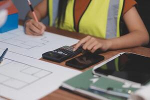Female architect working at home She looked at the blueprint. photo