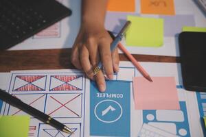 The designer team is designing the uxui system to make the uxui system work well on new phones and support system updates. Website development concept UI UX front end designer photo
