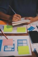 The designer team is designing the uxui system to make the uxui system work well on new phones and support system updates. Website development concept UI UX front end designer photo