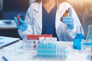 Group of dedicated scientist conduct chemical experiment in medical laboratory, carefully drop precise amount of liquid from pipette into test tube for vaccine drug or antibiotic development. Neoteric photo