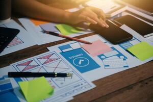 The designer team is designing the uxui system to make the uxui system work well on new phones and support system updates. Website development concept UI UX front end designer photo