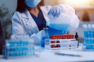 Group of dedicated scientist conduct chemical experiment in medical laboratory, carefully drop precise amount of liquid from pipette into test tube for vaccine drug or antibiotic development. Neoteric photo