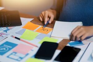 The designer team is designing the uxui system to make the uxui system work well on new phones and support system updates. Website development concept UI UX front end designer photo