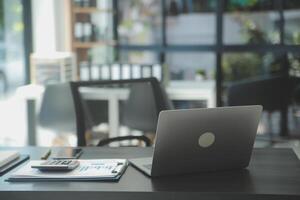 Entrepreneur Asian businessman and businesswoman discussing new business project in tablet in modern Meeting In Modern Office, Asian business casual concept. photo