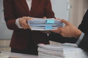 Audit concept,Administrator business man financial inspector and secretary making report calculating balance. Internal Revenue Service checking document. photo