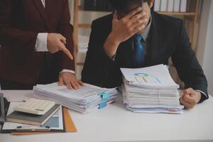 Audit concept,Administrator business man financial inspector and secretary making report calculating balance. Internal Revenue Service checking document. photo