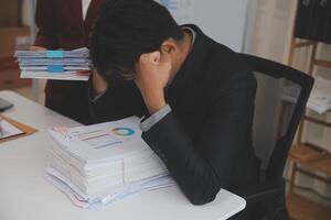 Audit concept,Administrator business man financial inspector and secretary making report calculating balance. Internal Revenue Service checking document. photo