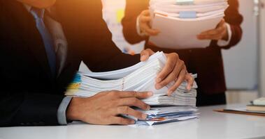 Audit concept,Administrator business man financial inspector and secretary making report calculating balance. Internal Revenue Service checking document. photo