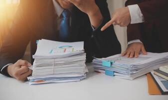 Audit concept,Administrator business man financial inspector and secretary making report calculating balance. Internal Revenue Service checking document. photo