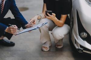 A young businesswoman is navigating car insurance options at her desk, considering premiums, deductibles, and coverage while understanding policies and managing claims efficiently. photo