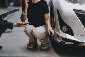 A young businesswoman is navigating car insurance options at her desk, considering premiums, deductibles, and coverage while understanding policies and managing claims efficiently. photo