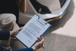 A young businesswoman is navigating car insurance options at her desk, considering premiums, deductibles, and coverage while understanding policies and managing claims efficiently. photo