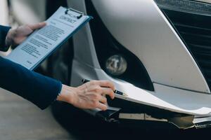 A young businesswoman is navigating car insurance options at her desk, considering premiums, deductibles, and coverage while understanding policies and managing claims efficiently. photo