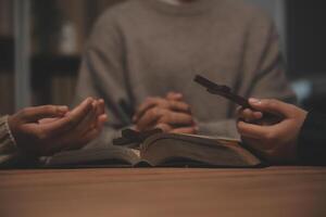 Christian group are praying to god with the bible and sharing the gospel. Concept of faith for god. photo